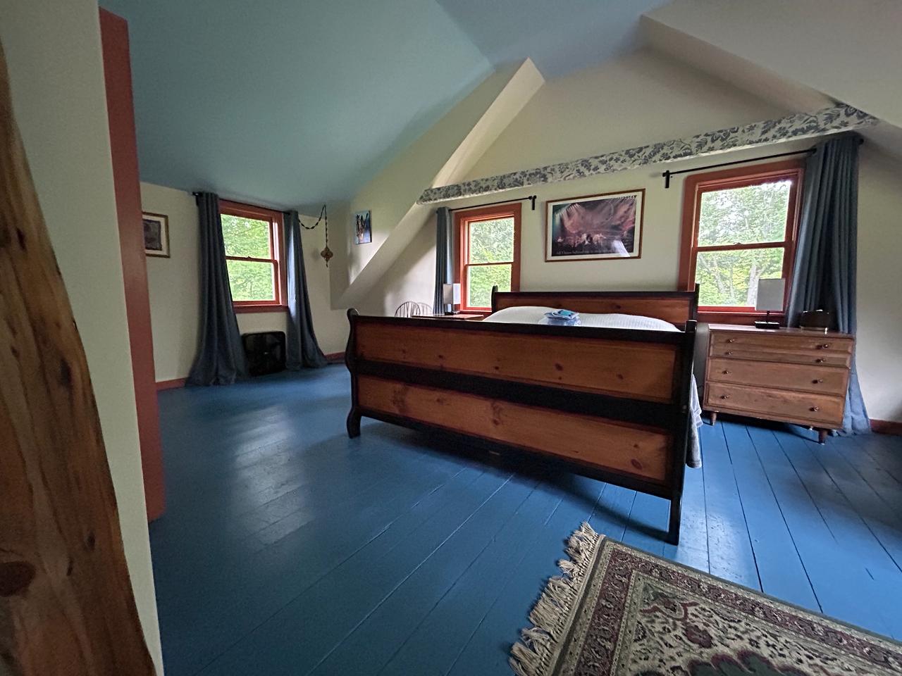 Master bedroom with blue painted floors