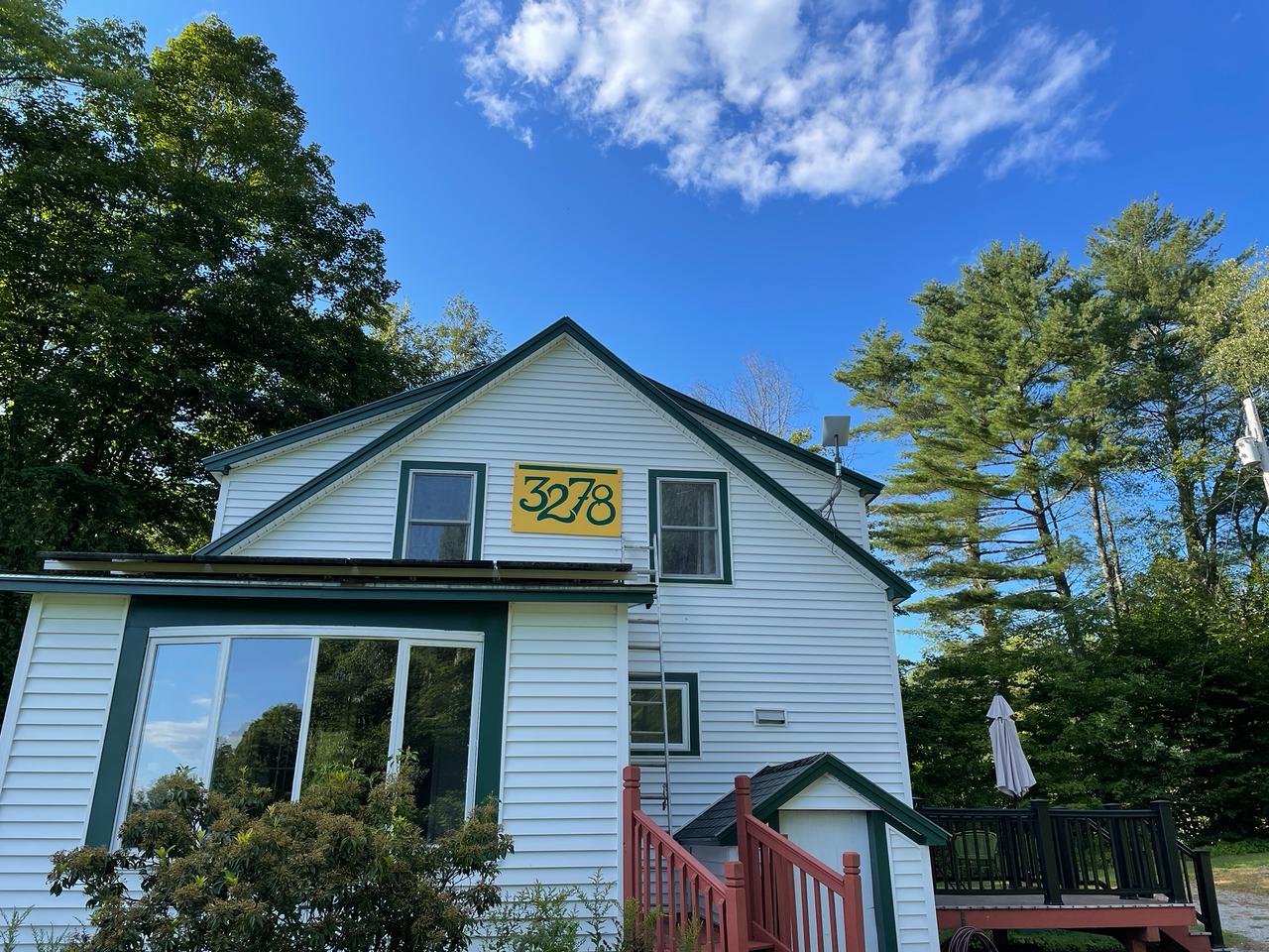 White farmhouse exterior with address 3278