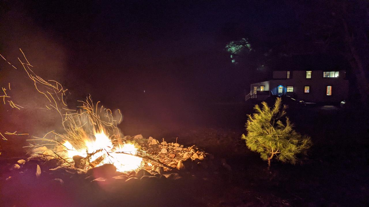 Outdoor fire pit roaring at night