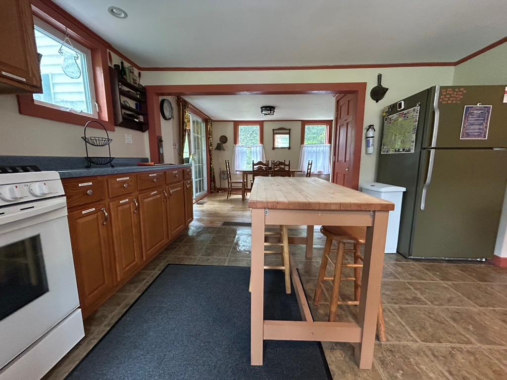 Rustic kitchen with butcher block island and gas stove